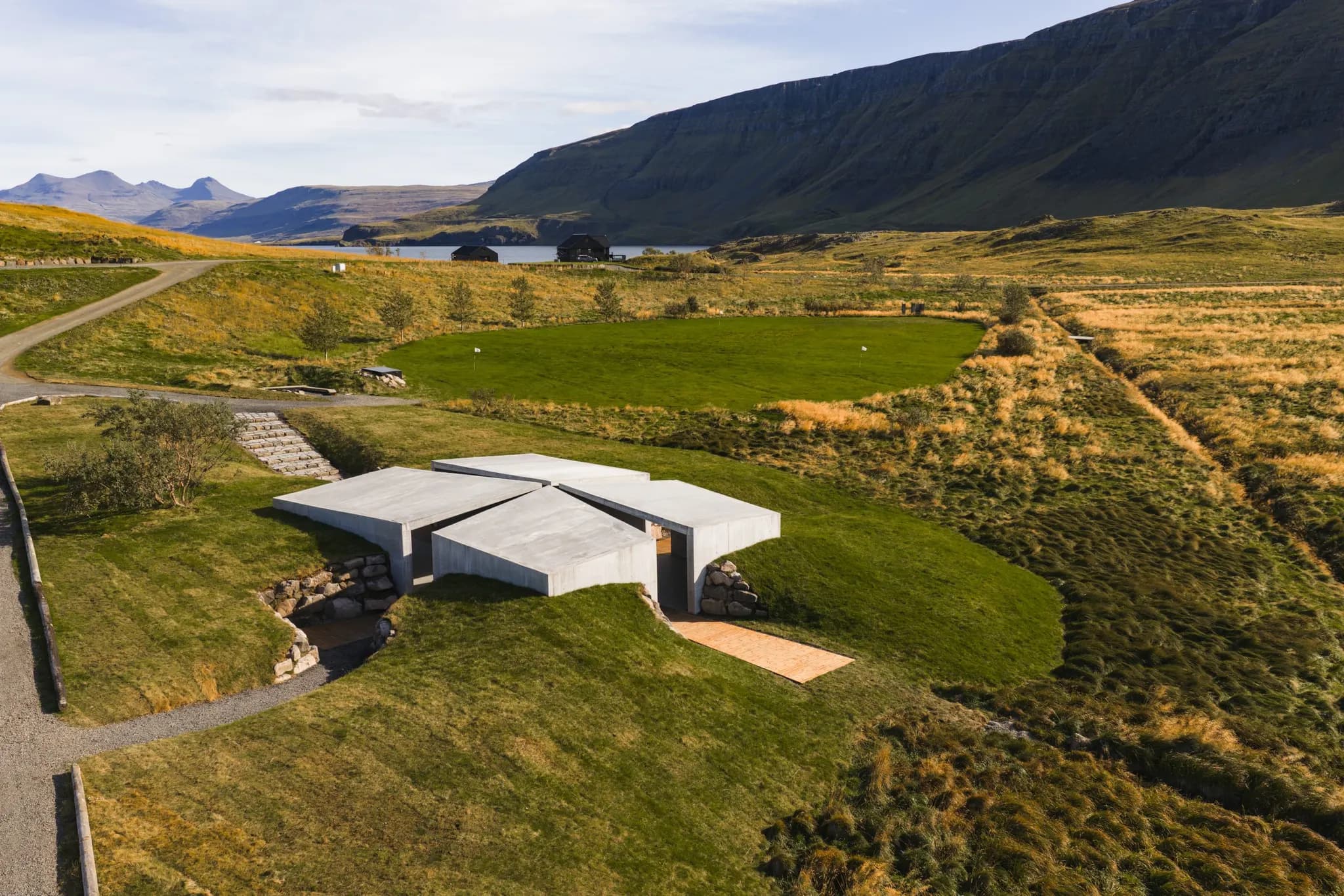 Aerial view over the Hvammsvík estate, the fjord and the mountains