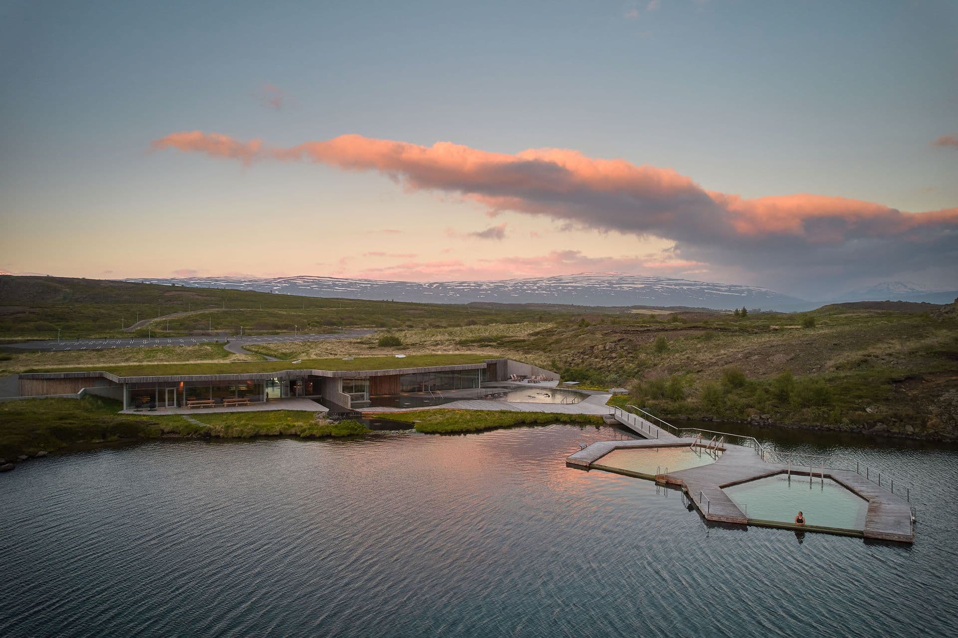 Urriðavatn lake at dusk under a pink sky