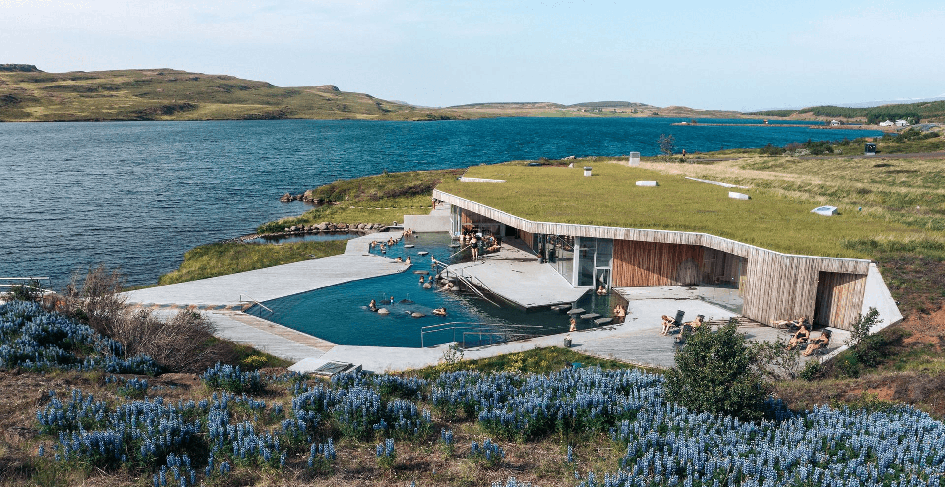 Aerial view of the grass-roofed Vök Baths building, pools and lakeshore