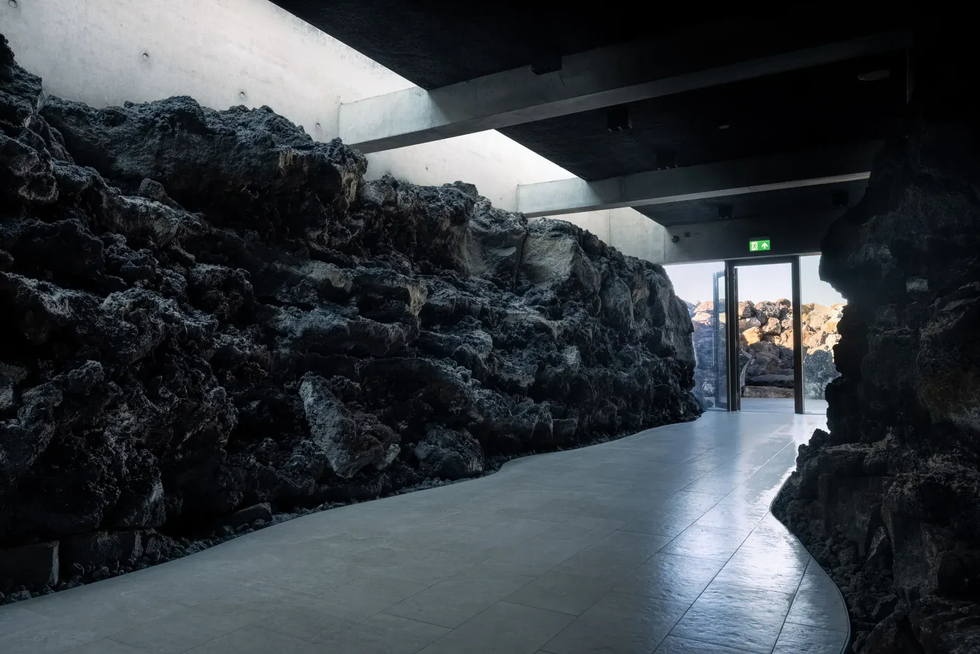 A passage in the new building, with a lava-rock wall and a skylight
