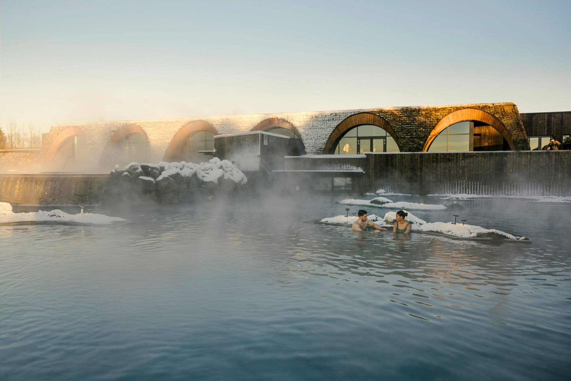 The steaming lagoon with turf-roofed buildings beyond